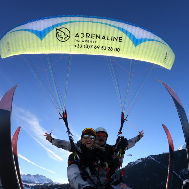 Paragliding tandem flight in winter at Courchevel